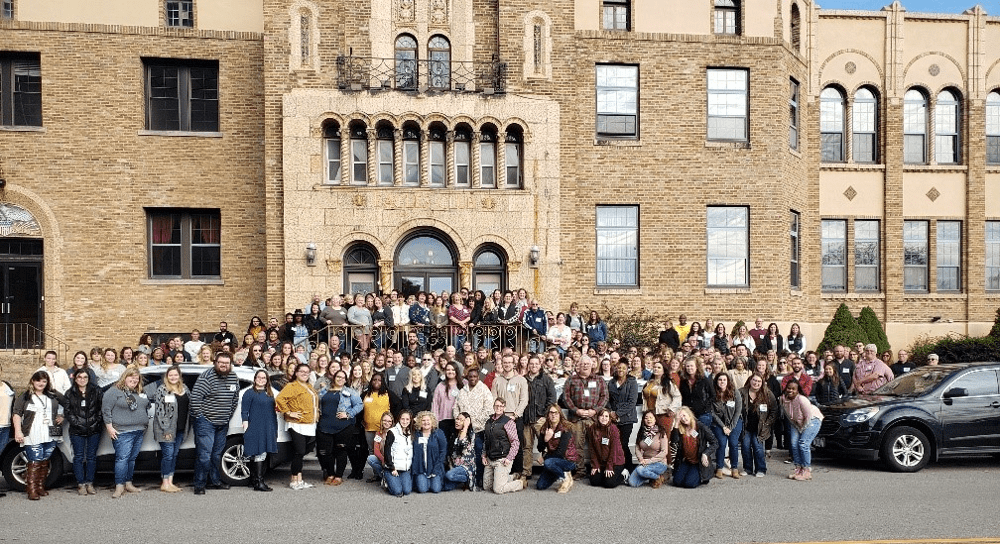 A large group photo outside